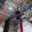 Aerial silks student holds a straddle position whilst hanging from the silks