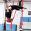 Male straps student holds a fish position on aerial straps