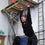 Aerial hoop student stands under the hoop smiling