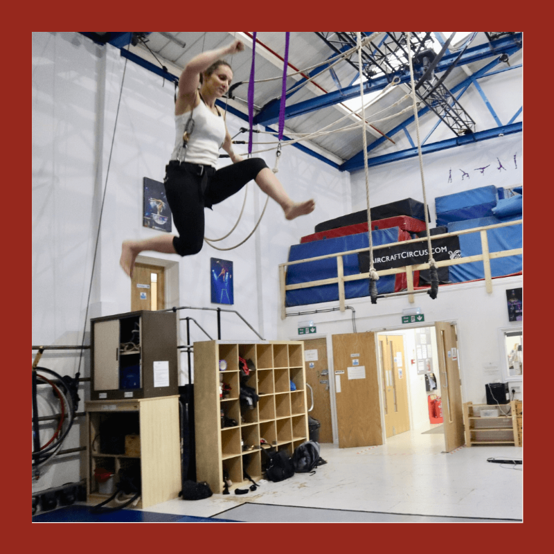 student flies through the air with the help of a harness