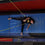Youth flying trapeze student lies on crash mats after practicing a trick